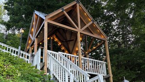 A wooden gazebo with a sloped roof, white railings, and a staircase leading up to it. - Lakefront Retreat w/ Private Dock, Game Room & Sunset Views - Sleeps 16 (Winchester)