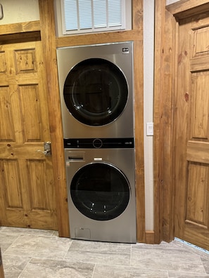 A double-door laundry room with two LG front-loading washing machines. - Large, luxury cabin, sleeps 19 with a gourmet kitchen, hot tub & fire pit (Angel Fire)