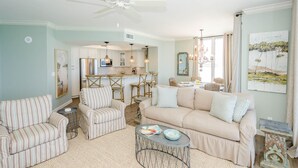 A living room with a sofa, armchairs, a coffee table, and a dining area with chairs and a table. - FIRST WEEK OF AUGUST JUST OPENED! (Destin)