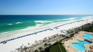 A beach resort with a long stretch of beach, a swimming pool, and a clear view of the ocean. - FIRST WEEK OF AUGUST JUST OPENED! (Destin)