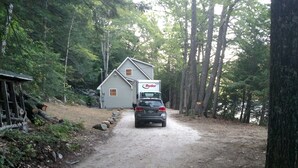 A gravel path leading to a house with a Ryder truck parked in front.