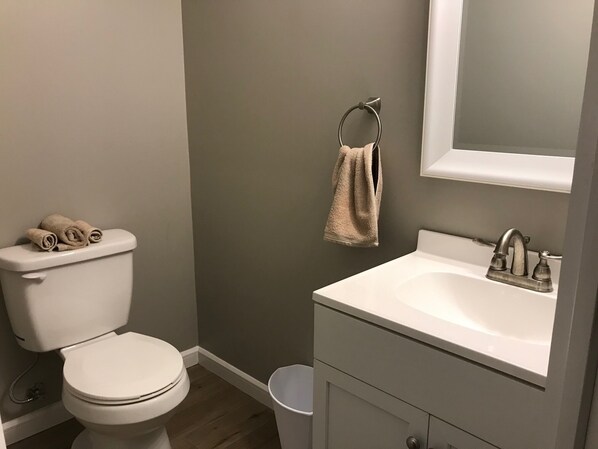 A bathroom with a toilet, sink, and a towel hanging on the wall. - Quiet, Private 2 BR/1.5BA Unit ~ Lake View, next to Wood Creek Boat Dock (London)
