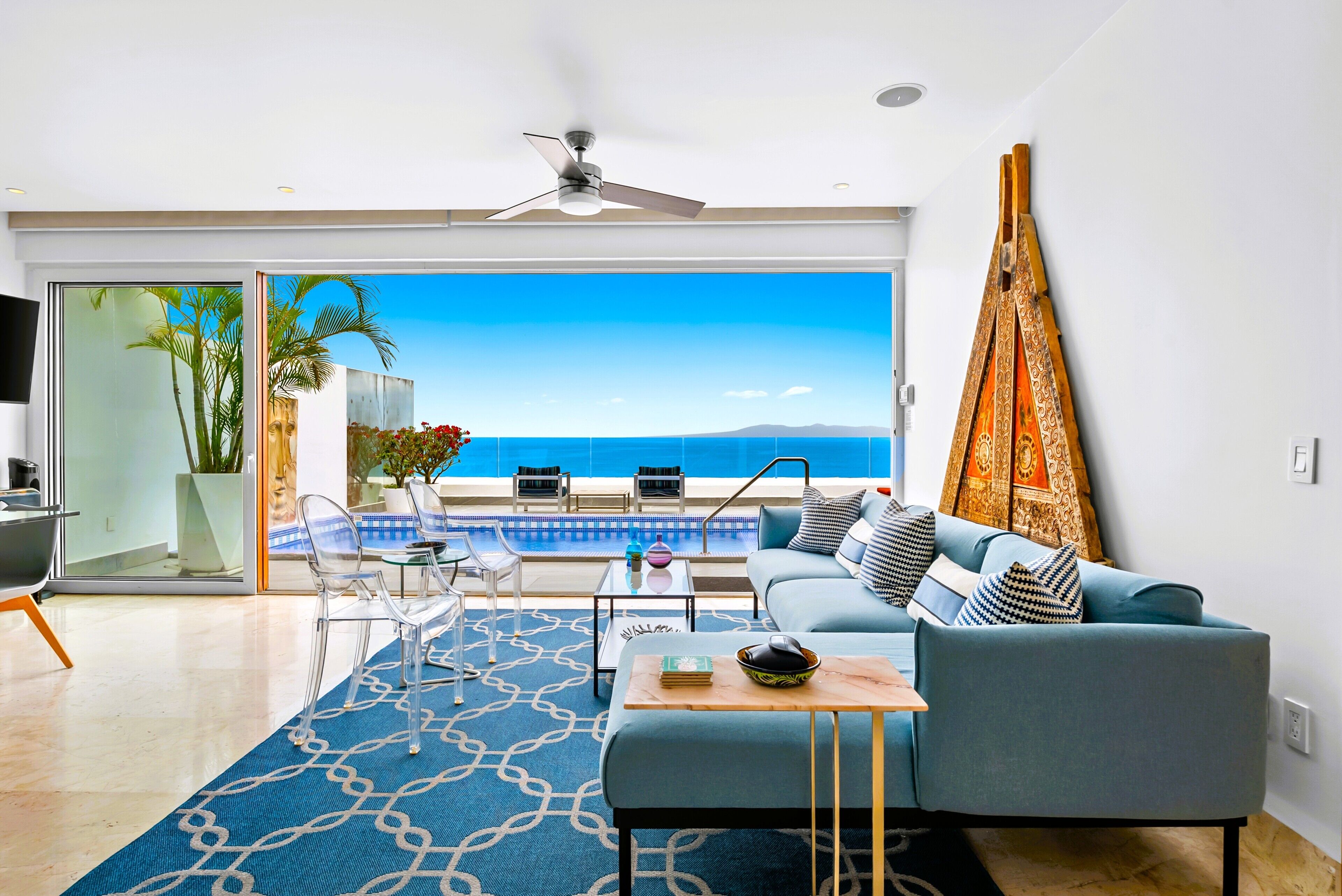 Antique filled upper level living room open to terrace with panoramic ocean view