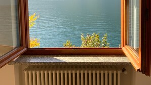 A room with a window overlooking a lake and mountains. - Outdoor Veranda w Lakefront Views, Lake Access & Swimming Dock (COMO)