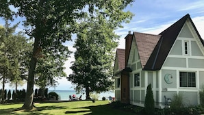 A house with a sloped roof, a visible chimney, and a number '113' on the side. - Truly a slice of heaven a must see! (Innisfil)