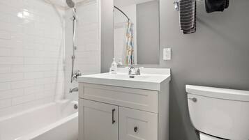 Bathtub, towels, soap, toilet paper