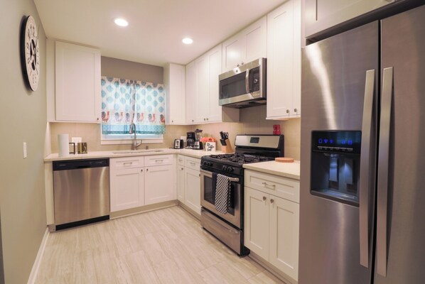 Enjoy cooking in this well-equipped kitchen with a dishwasher, oven, and refrigerator.