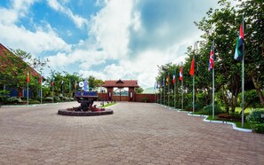 A paved entrance with a sign reading "For Retreat" and multiple flags.