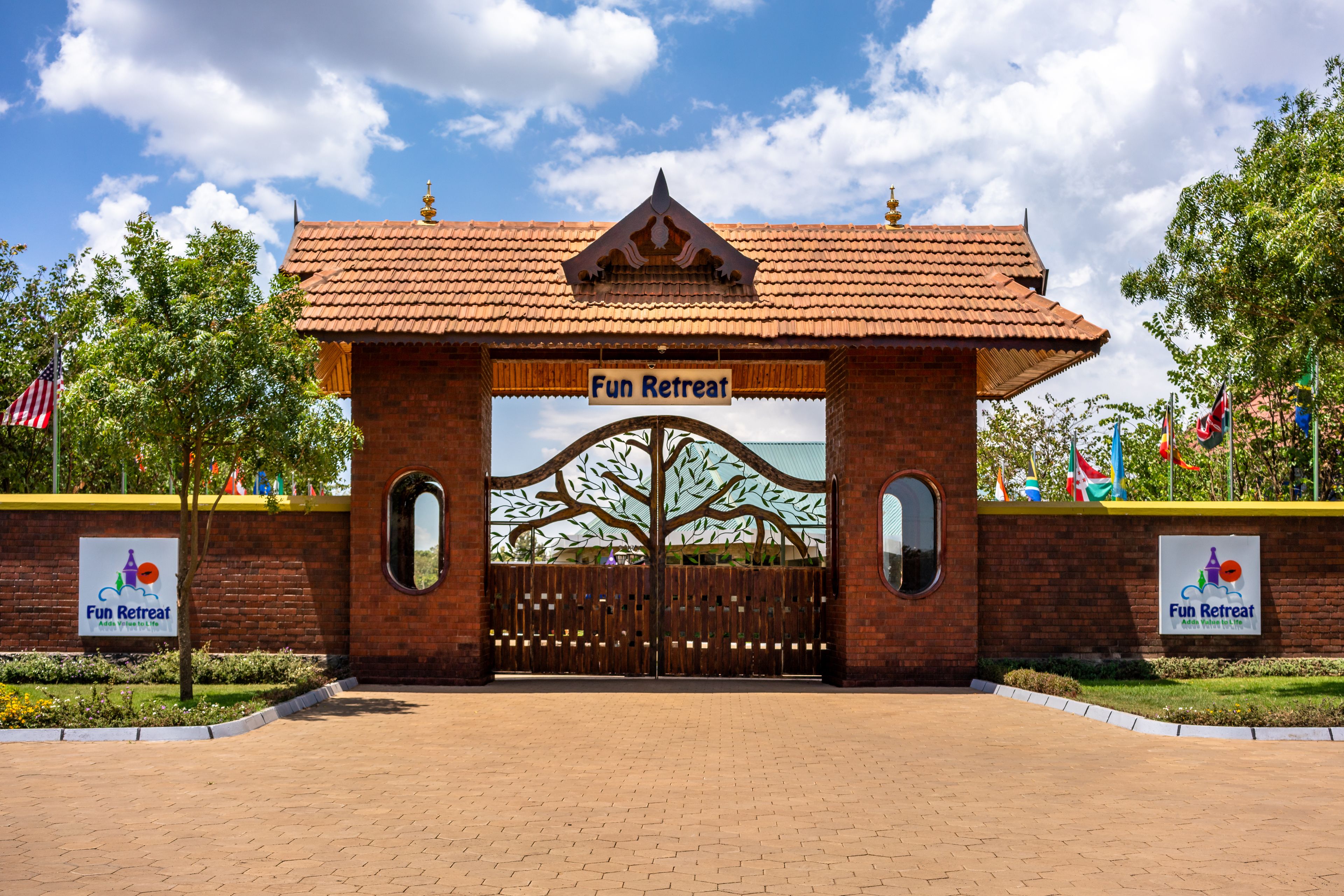 A brick entrance with a tiled roof and a tree motif, labeled "Fun Retreat."