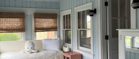 A bedroom with a bed, a nightstand, and a wardrobe.