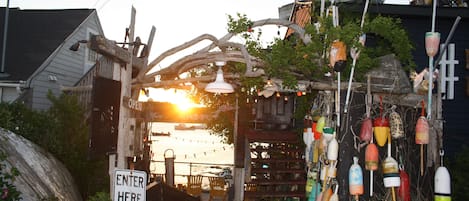 A rustic wooden structure with a sign reading "ENTER HERE".