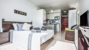 A modern hotel room with a large bed, a desk, and a kitchenette. - Incredible Relax Studio with Mountain Views and High Speed WIFI (Puerto de la Cruz)