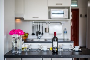 Fridge, microwave, stovetop, coffee/tea maker