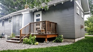 A two-story house with a wooden deck and a small front porch. - Stunningly Remodeled Historic Home Near Downtown (Bozeman)
