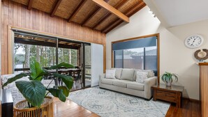 A spacious living room with a large window, a sofa, a coffee table, and a plant. - Kings Point Lake House - Family Getaway
Wake up to peaceful lake views (Kings Point)