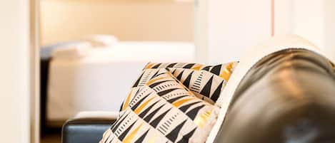 Un salón con sofá y un cojín decorativo estampado.