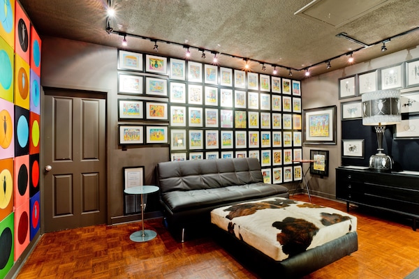 Media room with Serta sleeper sofa and flat screen.