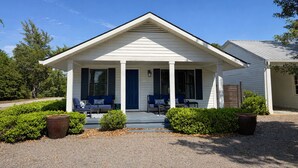 A single-story house with a porch, two windows, and a door. - 2BR/2BA Walk to downtown! Near the Beach! Perfect location! The Gallery (Ocean Springs)