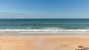 A beach with clear skies and calm waters. - Beachy Keen Platinum Property with Unbeatable View!   (Palm Coast)