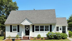 A single-story house with a front porch, a mailbox, and a well-maintained lawn.