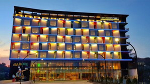 A multi-story hotel with a modern design, featuring a prominent signage for 'Maxone Hotels'. - MaxOneHotels.com at Balikpapan (Balikpapan)
