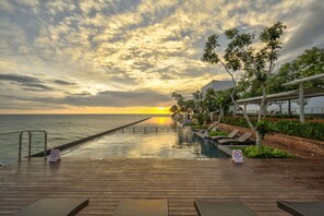 A wooden deck with a pool, lounge chairs, and a no diving sign. - Marino Beach Colombo (Colombo)