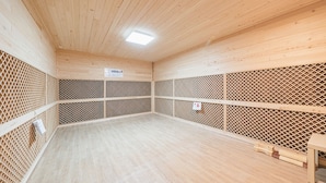 A sauna room with wooden walls and a slatted floor. - Jeju Healing Resort (Jeju City)