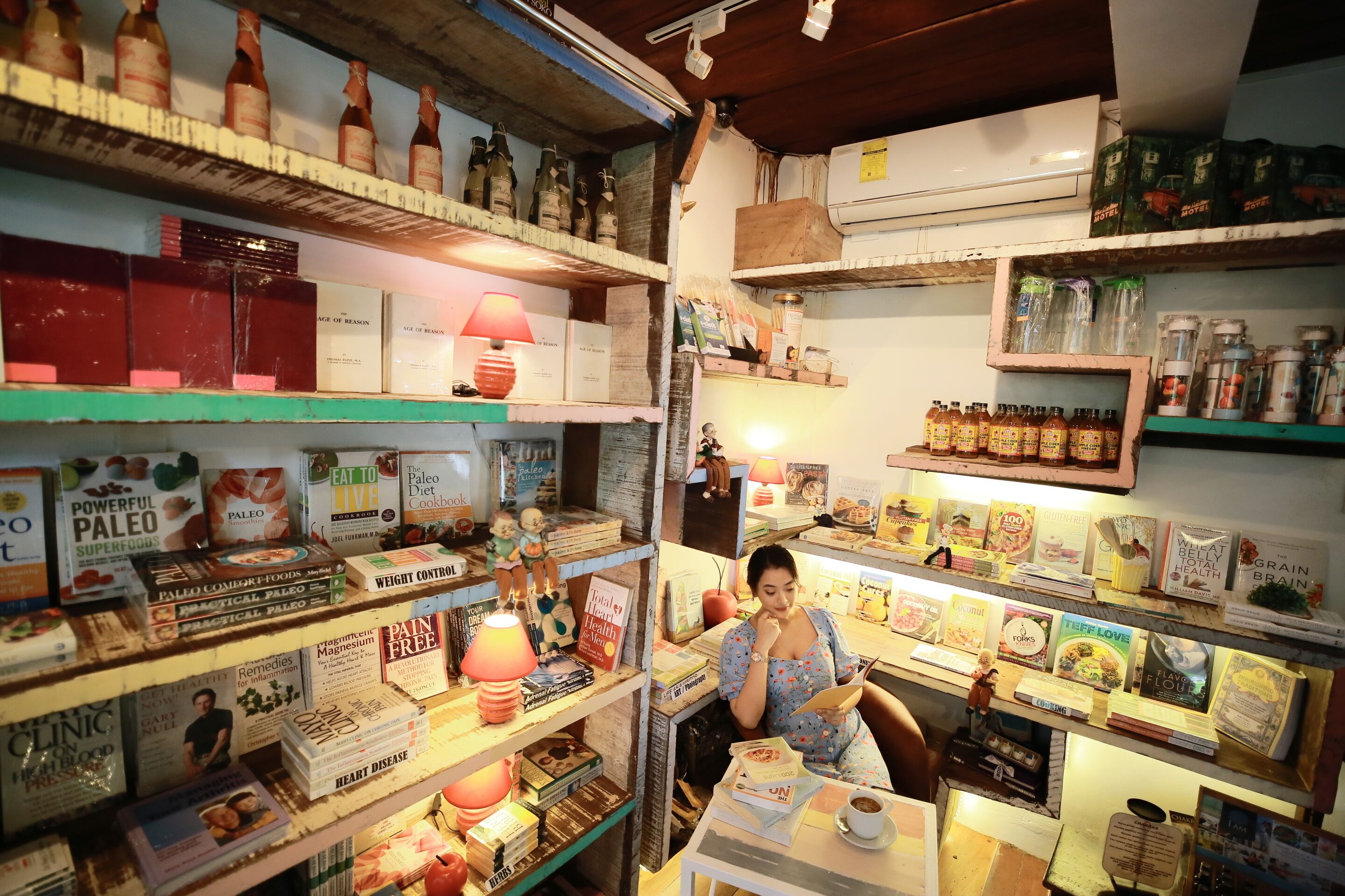 A bookstore with shelves stocked with books, health supplements, and other items.