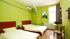 A room with two beds, a radiator, a window with curtains, and a small table with a chair. - Meet int'l Youth Hostel Zhejiang Rd (Qingdao)