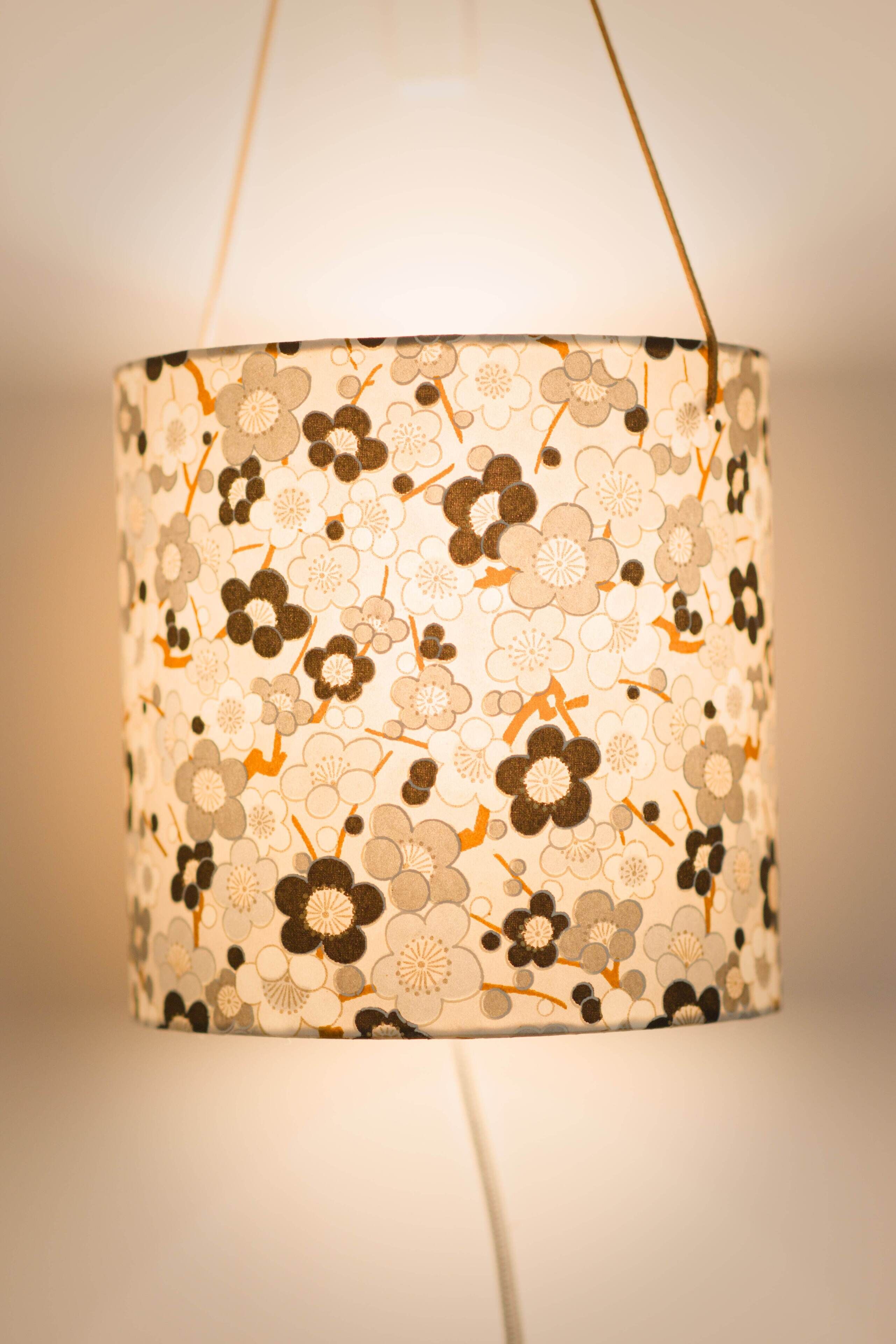 A hanging lamp with a floral pattern.