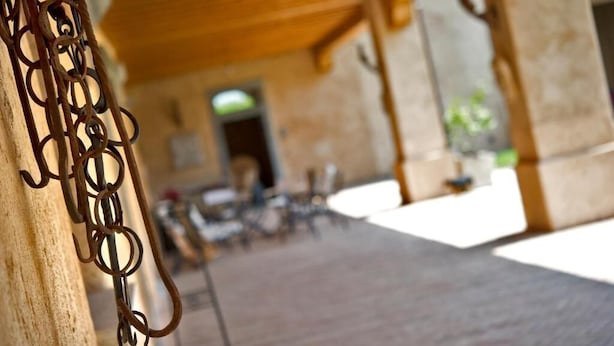 A covered outdoor area with a rustic wooden ceiling and a metal railing. - Corte Breda Agriturismo Bed & Breakfast (Chiari)