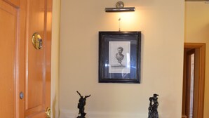 A wooden dresser with drawers and a framed picture above it. - La Baia di Napoli (Naples)