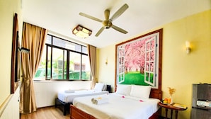 A hotel room with a large bed, two bedside tables, a ceiling fan, a window with curtains, and a wall-mounted light fixture. - Anh Family Homestay (Da Nang)