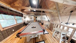 A wooden interior with a pool table, seating, and a staircase. - Streamsong Secluded Creek View Cabin with Hot Tub and Pool Table by RedAwning (Sevierville)