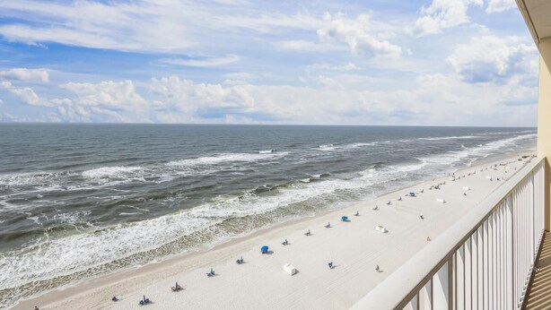 A beach with a clear sky and waves. - Crystal Shores 1104 2 Bedroom Condo by RedAwning (Gulf Shores)