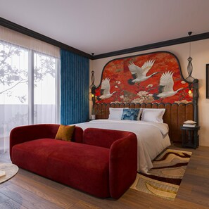 A bedroom with a large bed, a red sofa, and a wall mural. - Hanoi L'heritage Diamond Hotel & Spa (Hanoi)