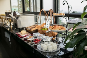 A buffet setup with various food items and beverages, including croissants, fruits, and milk. - Hanoi L'heritage Diamond Hotel & Spa (Hanoi)