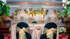 A banquet hall with a stage, chairs, and tables. - Horison Express Sentani (Sentani)