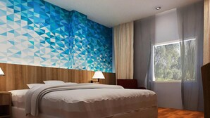 A modern hotel room with a geometric patterned wall, a large bed, wooden flooring, and a window with a view of trees. - Horison Express Sentani (Sentani)