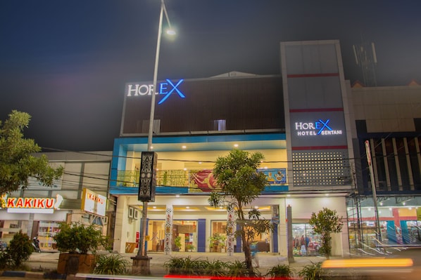 A hotel with a prominent 'HOREX' sign, multiple floors, and a visible entrance.