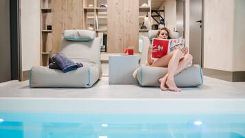 Relax by the pool with comfortable lounge chairs and a convenient table nearby.