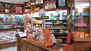 Una libreria con diverse sezioni, tra cui riviste, libri e biglietti d'auguri.