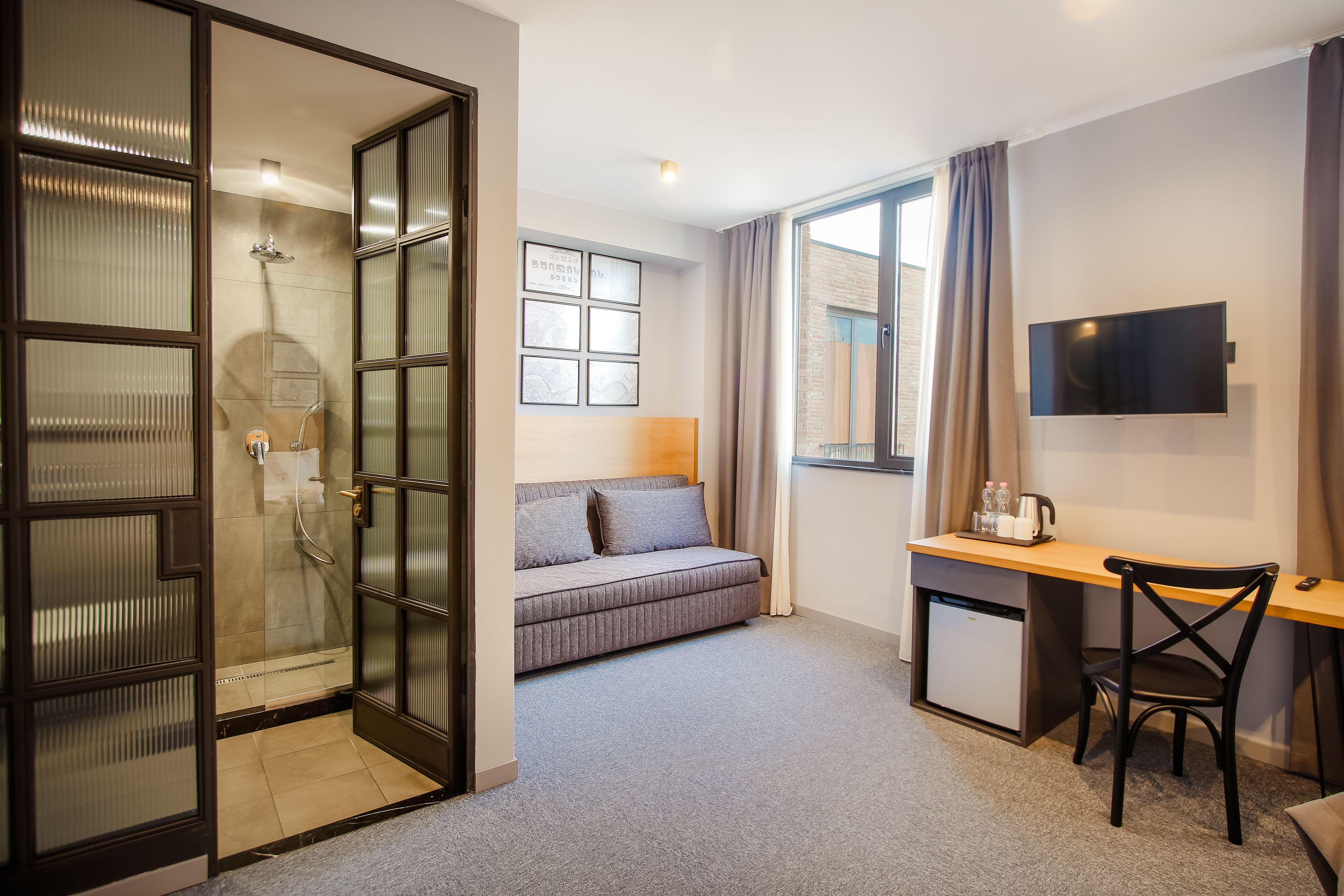 standard quadruple room (with sofa) | living area | flat-screen tv