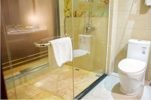 A bathroom with a glass-enclosed shower, a white toilet, and a towel rack. - Karen Hotel (Guangzhou)