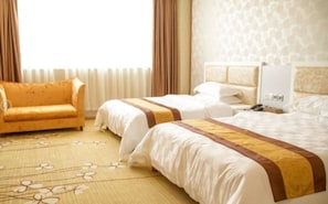 A hotel room with two beds, a sofa, and a large window with curtains. - Karen Hotel (Guangzhou)