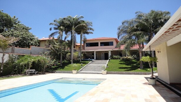A two-story house with a swimming pool in the foreground. - House in a gated community, 45 minutes from São Paulo. (ITATIBA)