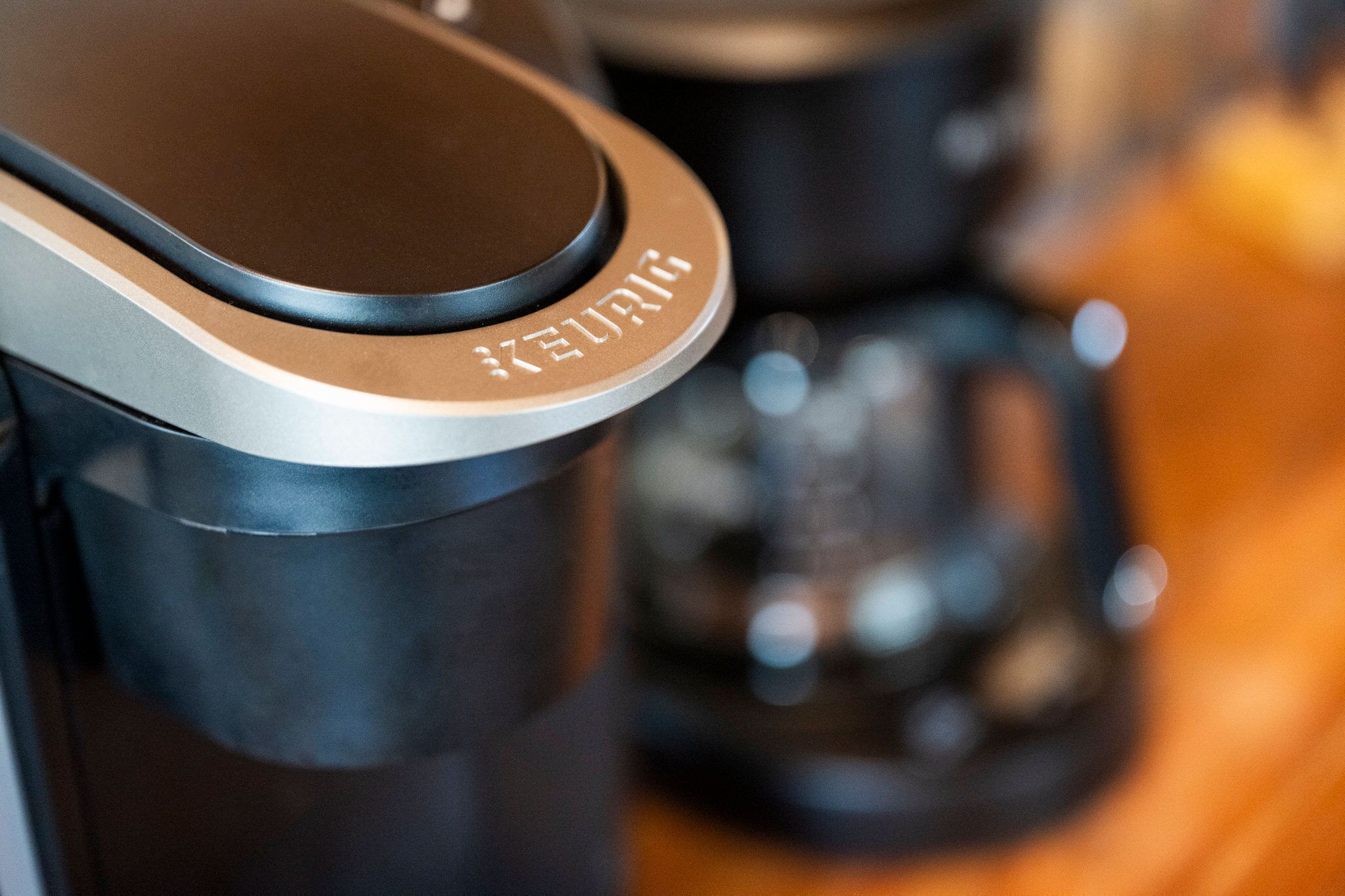 A close-up of a Keurig coffee machine with a black and silver design.