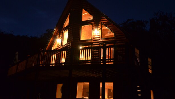 A wooden cabin with multiple windows and a balcony. - True North at Sunday River-Powder Ridge-4miles to Mtn. New Air Conditioning !! (Newry)