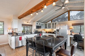 A spacious kitchen with a large island, modern appliances, and ample natural light from large windows. - Discover Prescott charm, just a 7-min drive from Whiskey Row with amazing views! (Prescott)