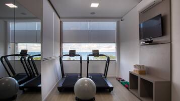 A gym with treadmills, a stationary bike, and exercise balls.